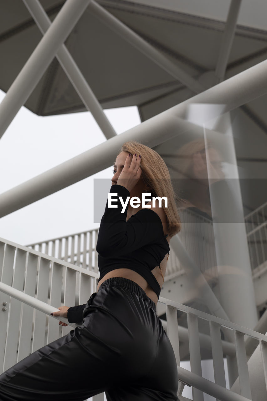 Low angle view of woman standing on staircase