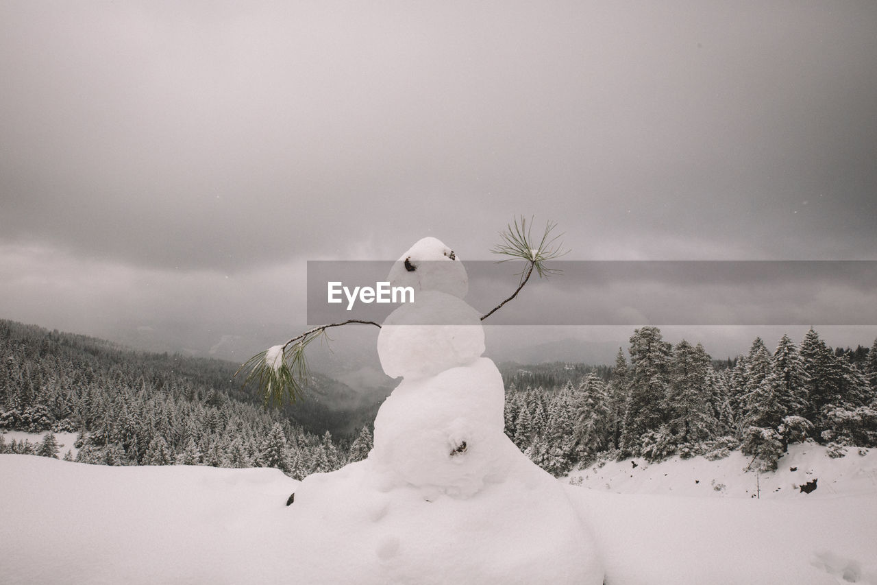 Snowman dancing on a scenic overlook