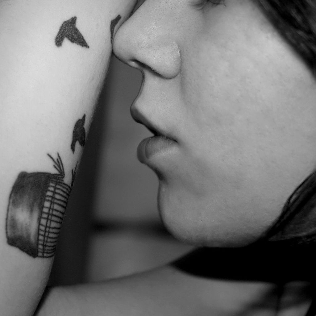 Cropped image of woman with tattoo on arm