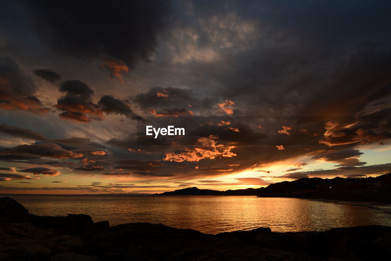 Scenic view of sea against dramatic sky