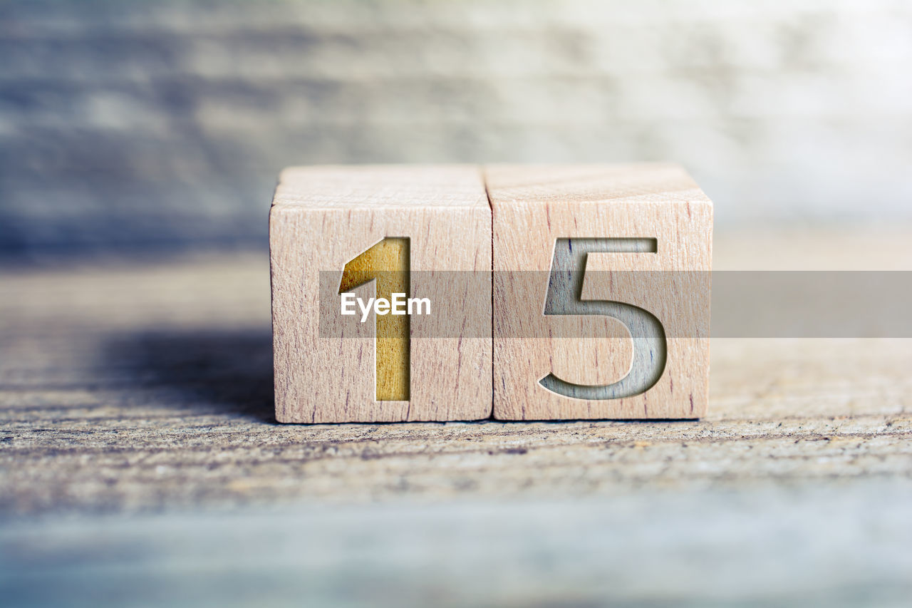 CLOSE-UP OF TOY ON WOOD AGAINST BLURRED BACKGROUND