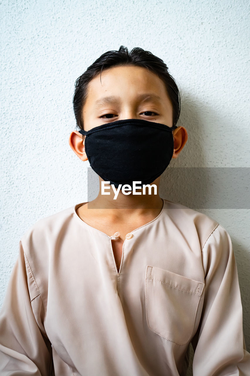 Asian young kids are wearing hygienic reusable face mask to prevent the virus. new normal.