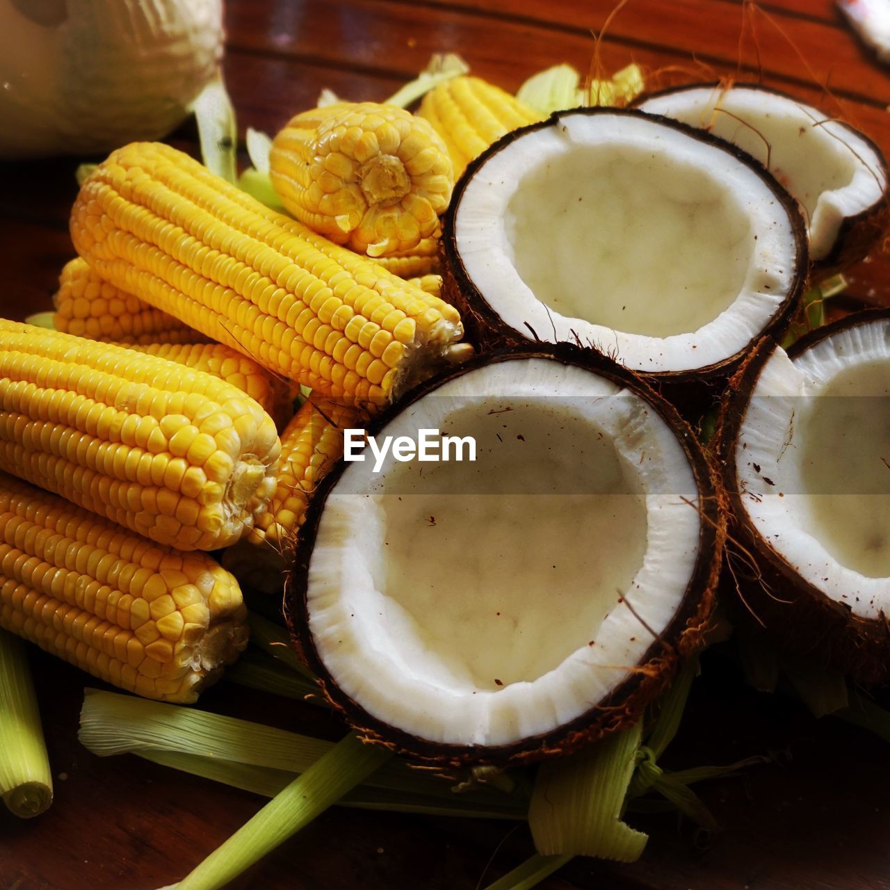 Close-up of corn on cobs with coconuts