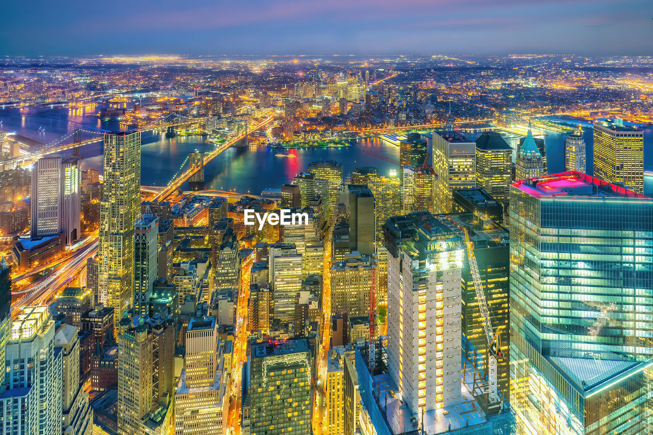 high angle view of illuminated cityscape against sky at night