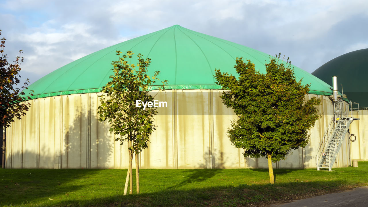 TENT ON FIELD AGAINST SKY