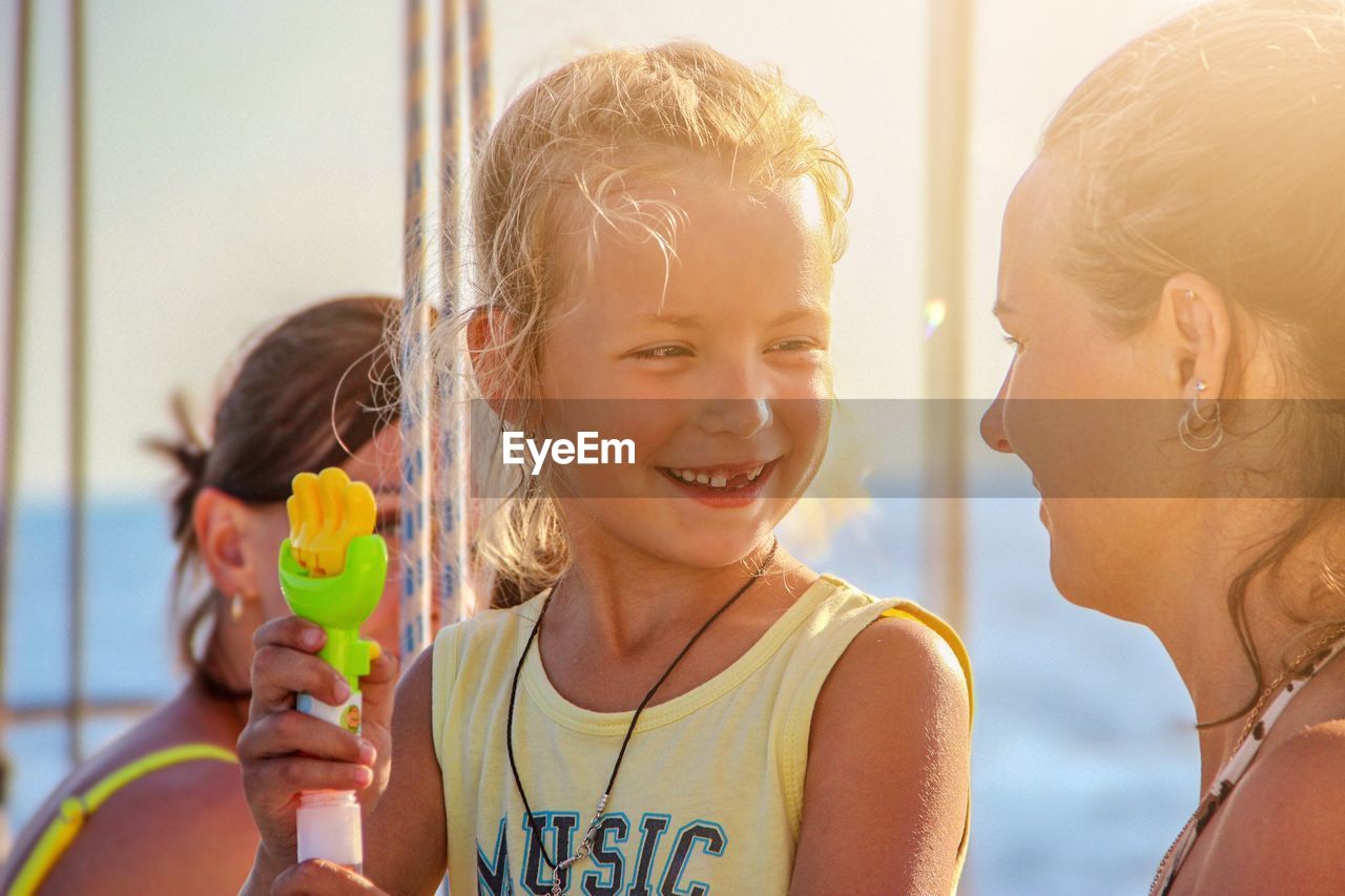 Portrait of happy girl holding camera