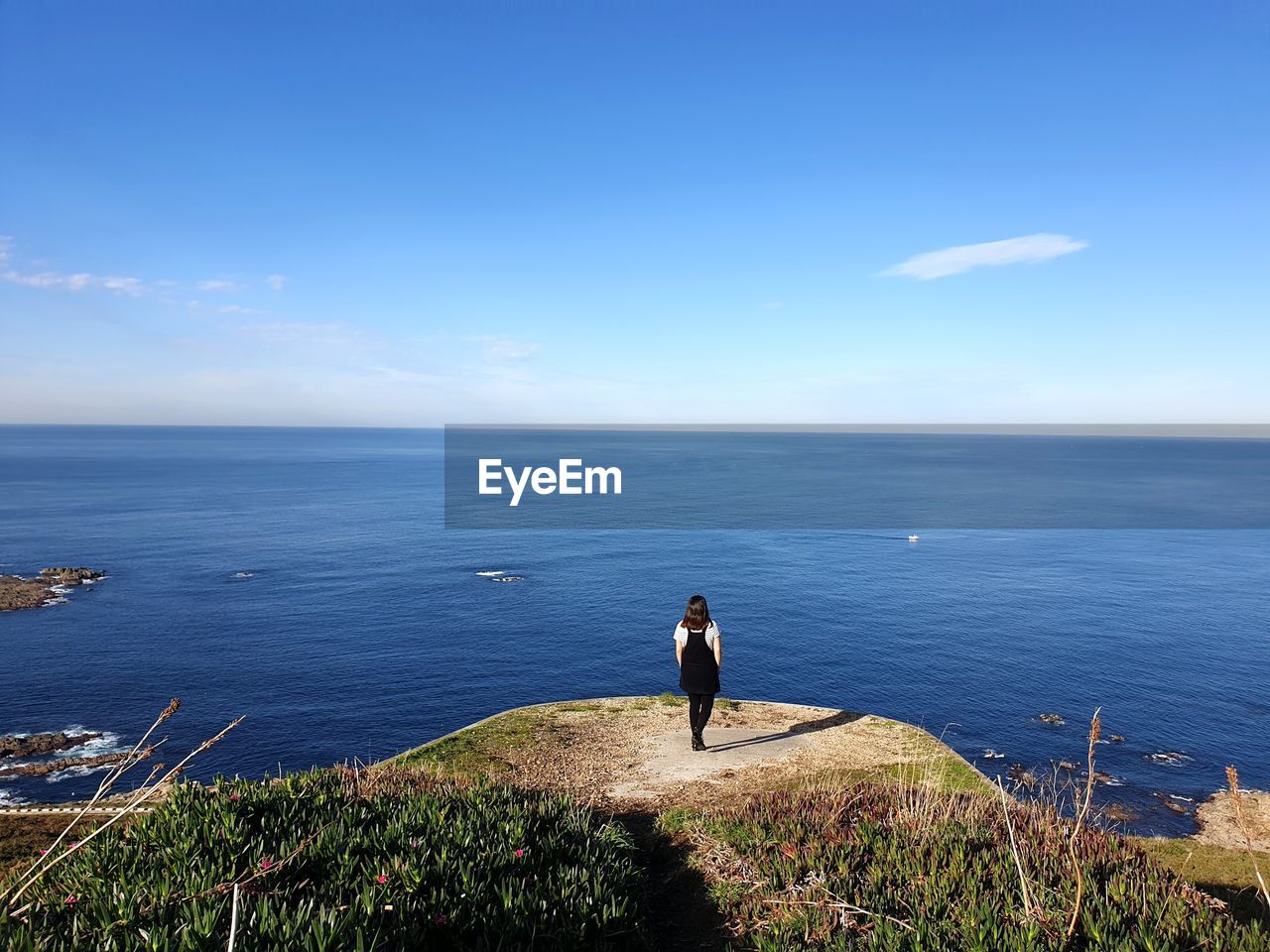 Woman looking at sea against sky