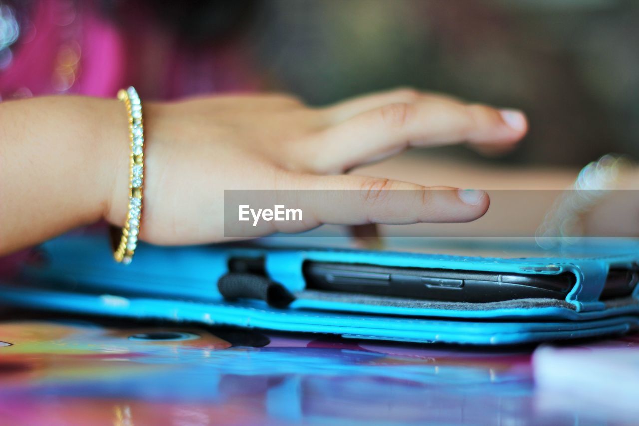 Close-up of hand touching smart phone