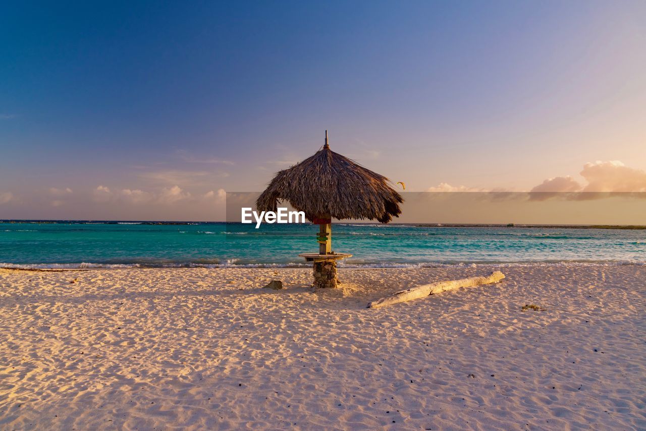 Scenic view of beach against sky during sunset