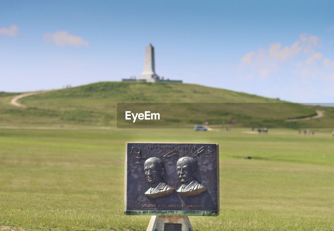 Close-up of memorial against countryside landscape