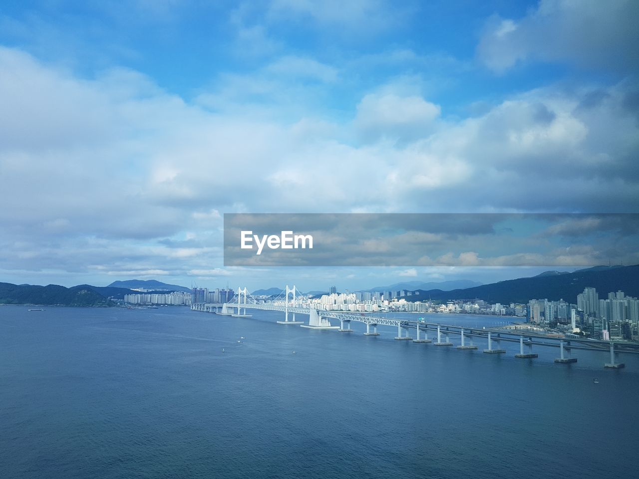 SCENIC VIEW OF SEA BY CITY AGAINST SKY