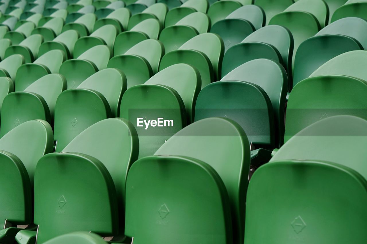 Full frame shot of green empty chairs
