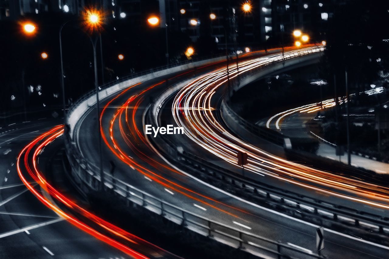 High angle view of light trails on highway at night