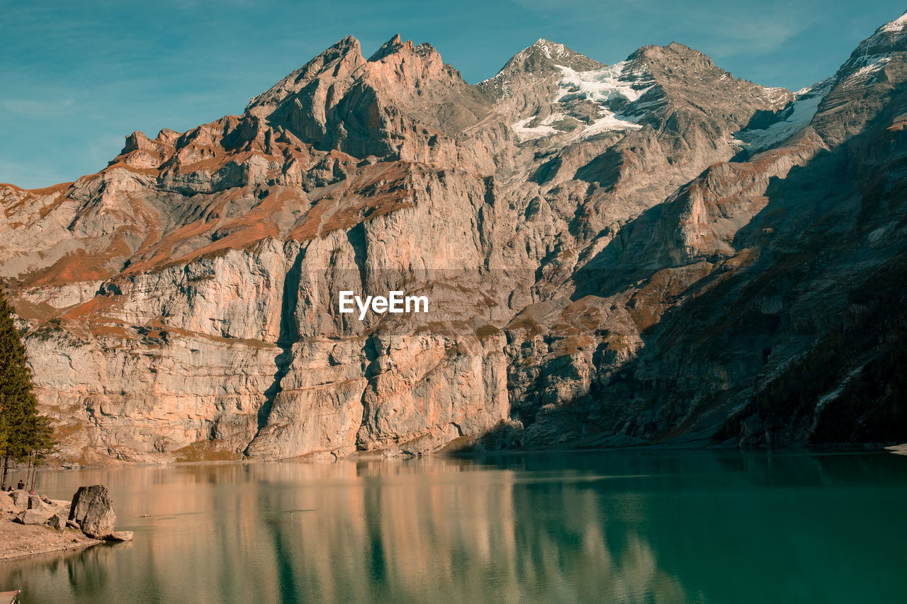 Scenic view of lake and mountains against sky