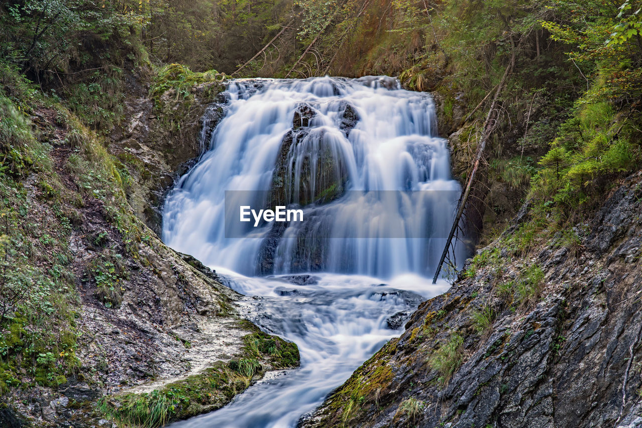 waterfall, beauty in nature, scenics - nature, water, environment, nature, plant, body of water, forest, motion, tree, land, rock, stream, watercourse, landscape, travel destinations, long exposure, no people, water feature, river, outdoors, flowing water, non-urban scene, travel, water resources, flowing, tourism, speed, idyllic, autumn, holiday