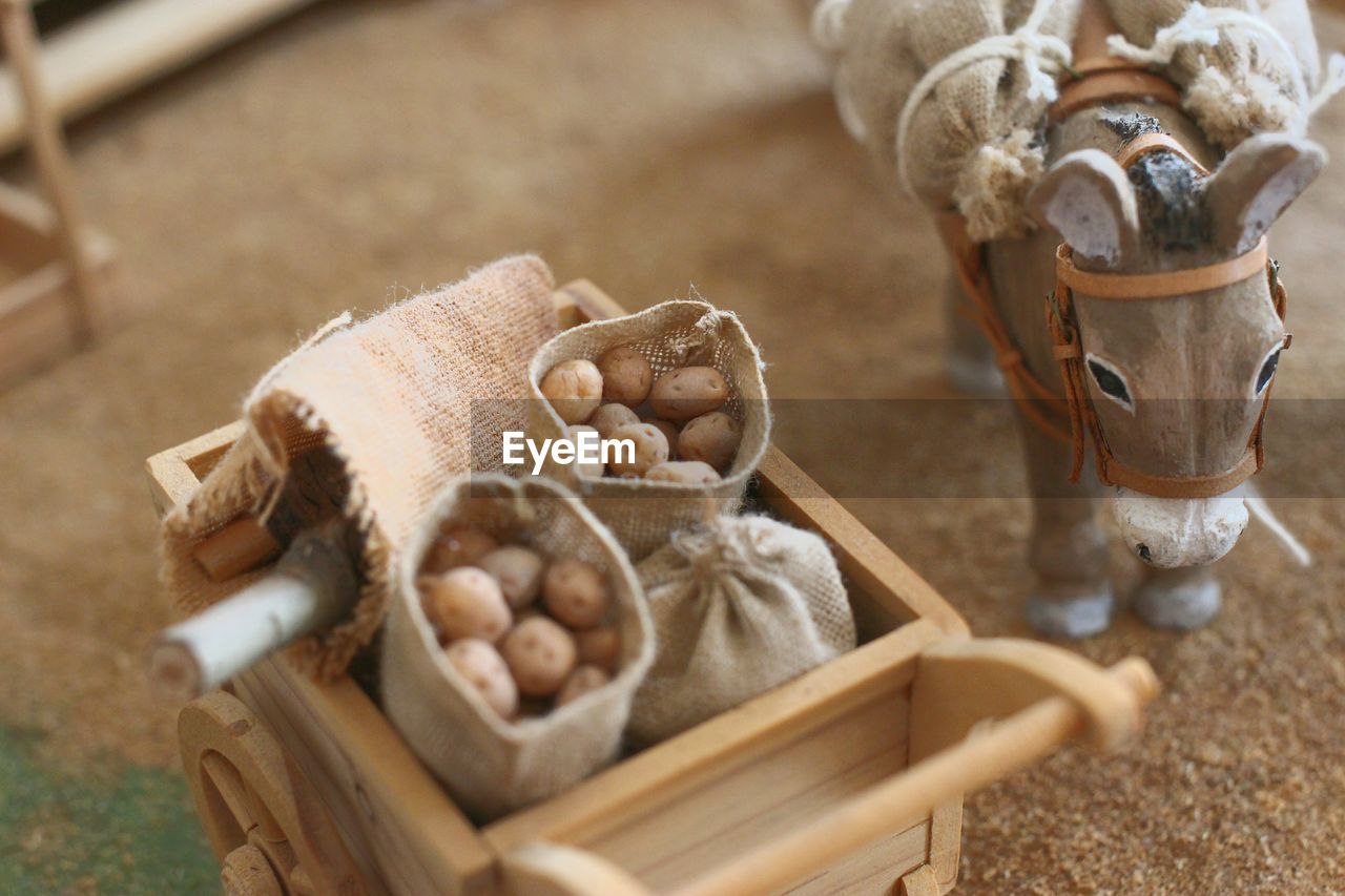 High angle view of potatoes in sack by toy
