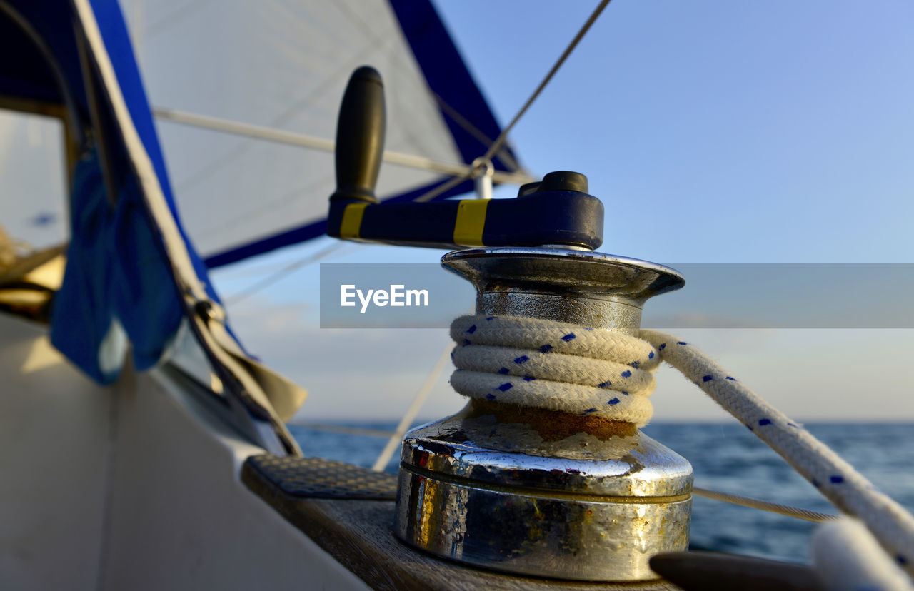 Close-up of sailboat in sea against sky