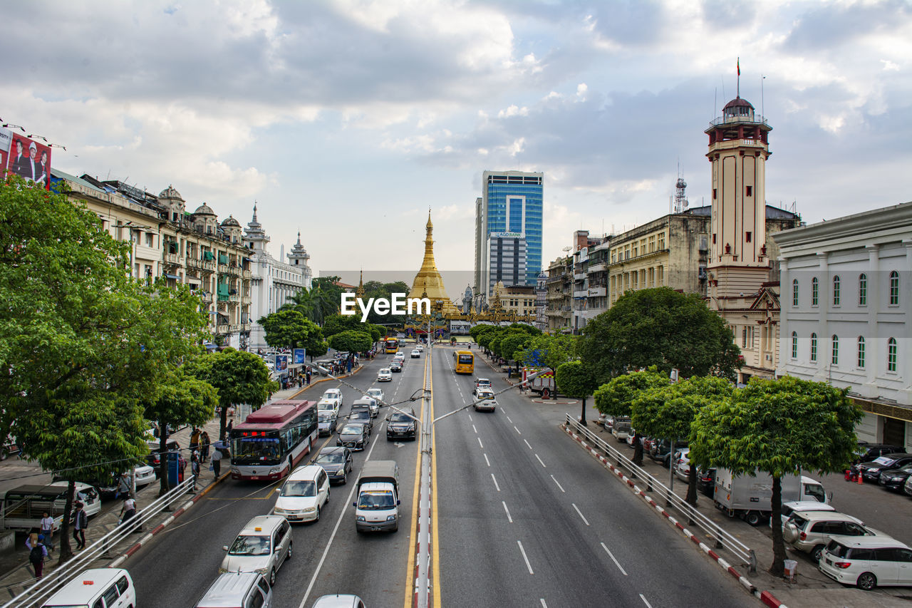 View of city street and buildings against sky