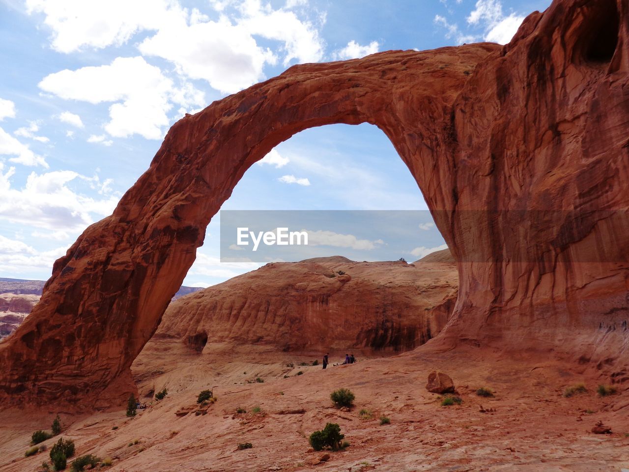 Rock formation by mountains at arches national park against sky