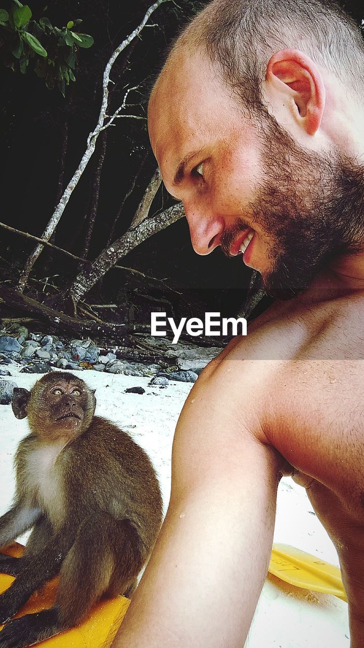 CLOSE-UP PORTRAIT OF SHIRTLESS MAN WITH WATER