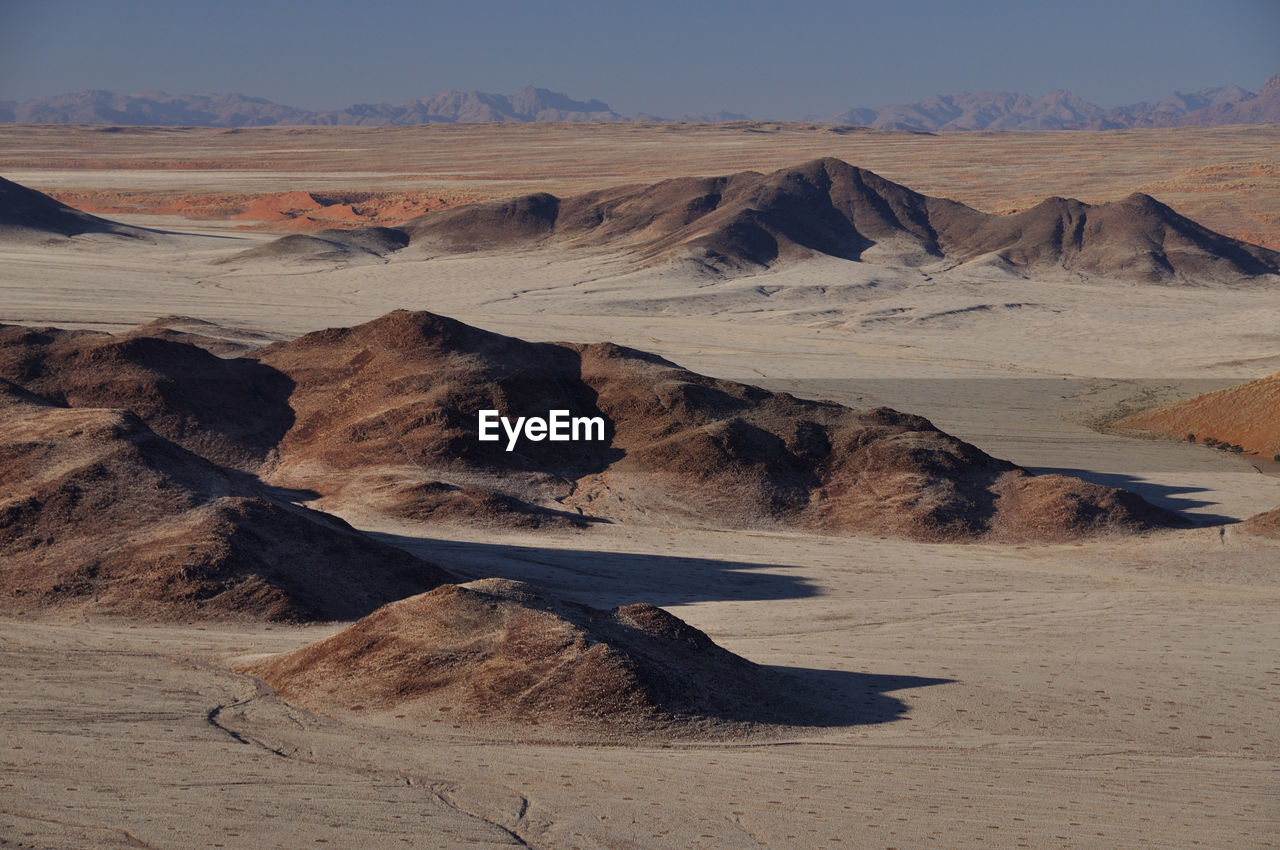 Scenic view of arid namib desert landscape against sky