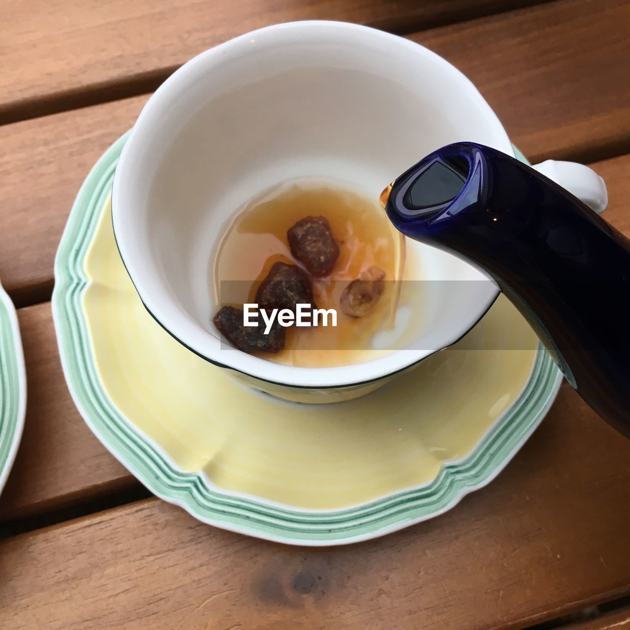 High angle view of pouring tea on table