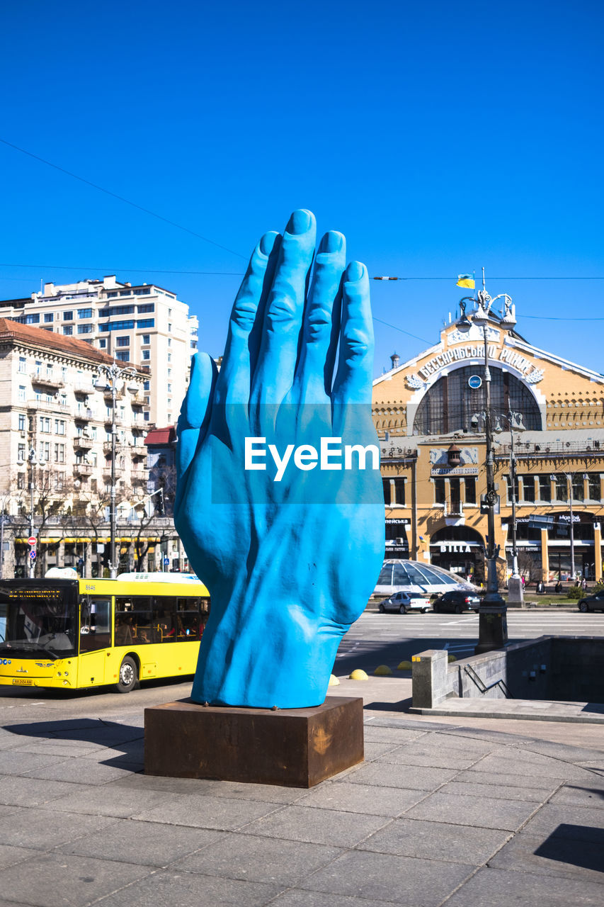 STATUE AGAINST BUILDINGS IN CITY