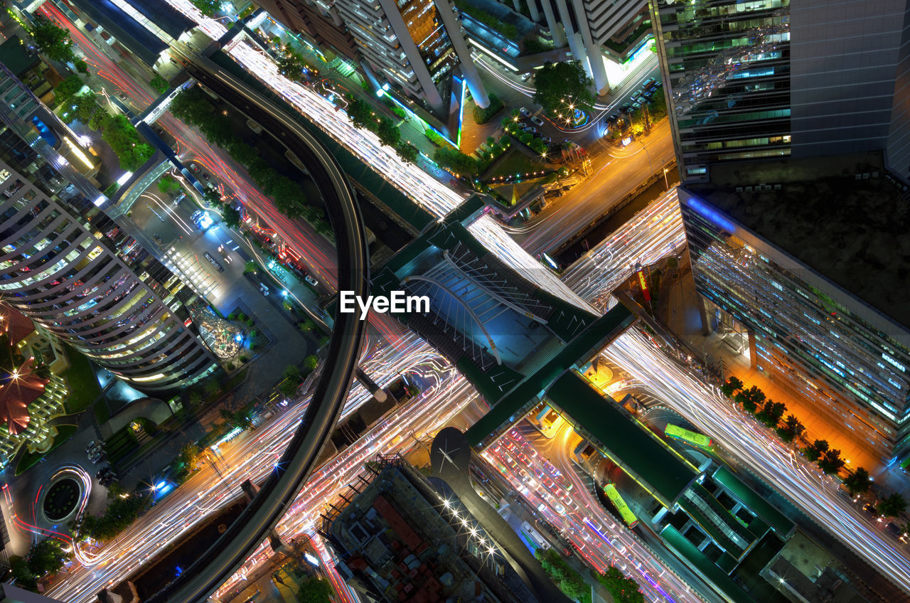 High angle view of illuminated city street and buildings at night