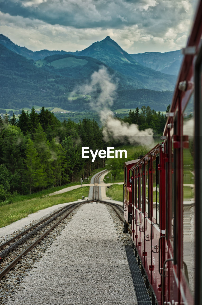 Train on railroad track against mountain