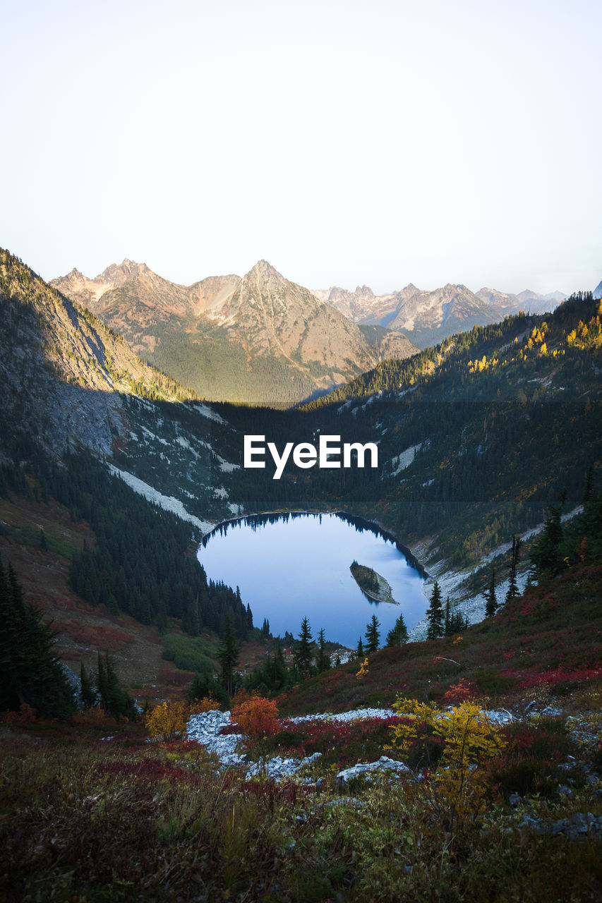 Scenic view of lake and mountains against clear sky