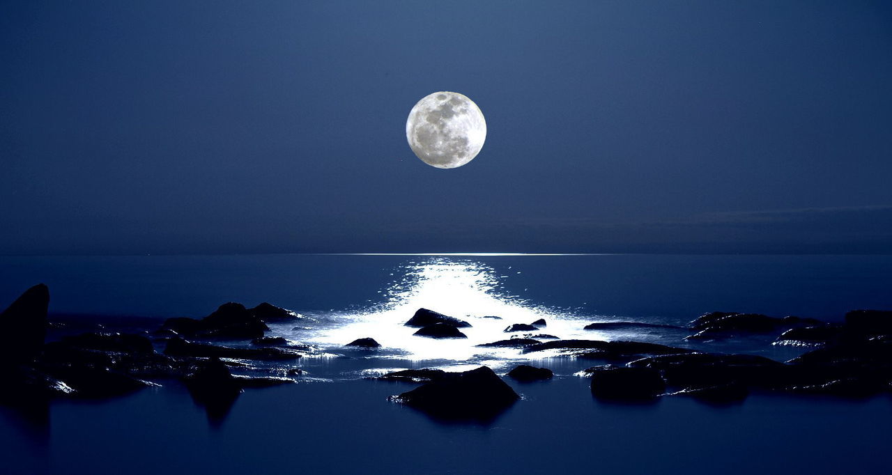 SCENIC VIEW OF MOON OVER CALM LAKE