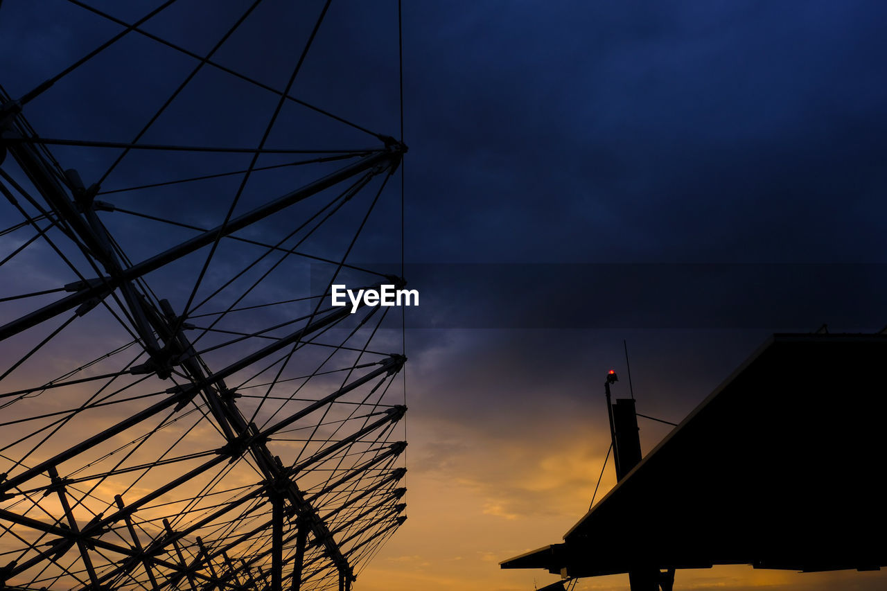 LOW ANGLE VIEW OF SILHOUETTE BUILDINGS AGAINST SKY AT SUNSET