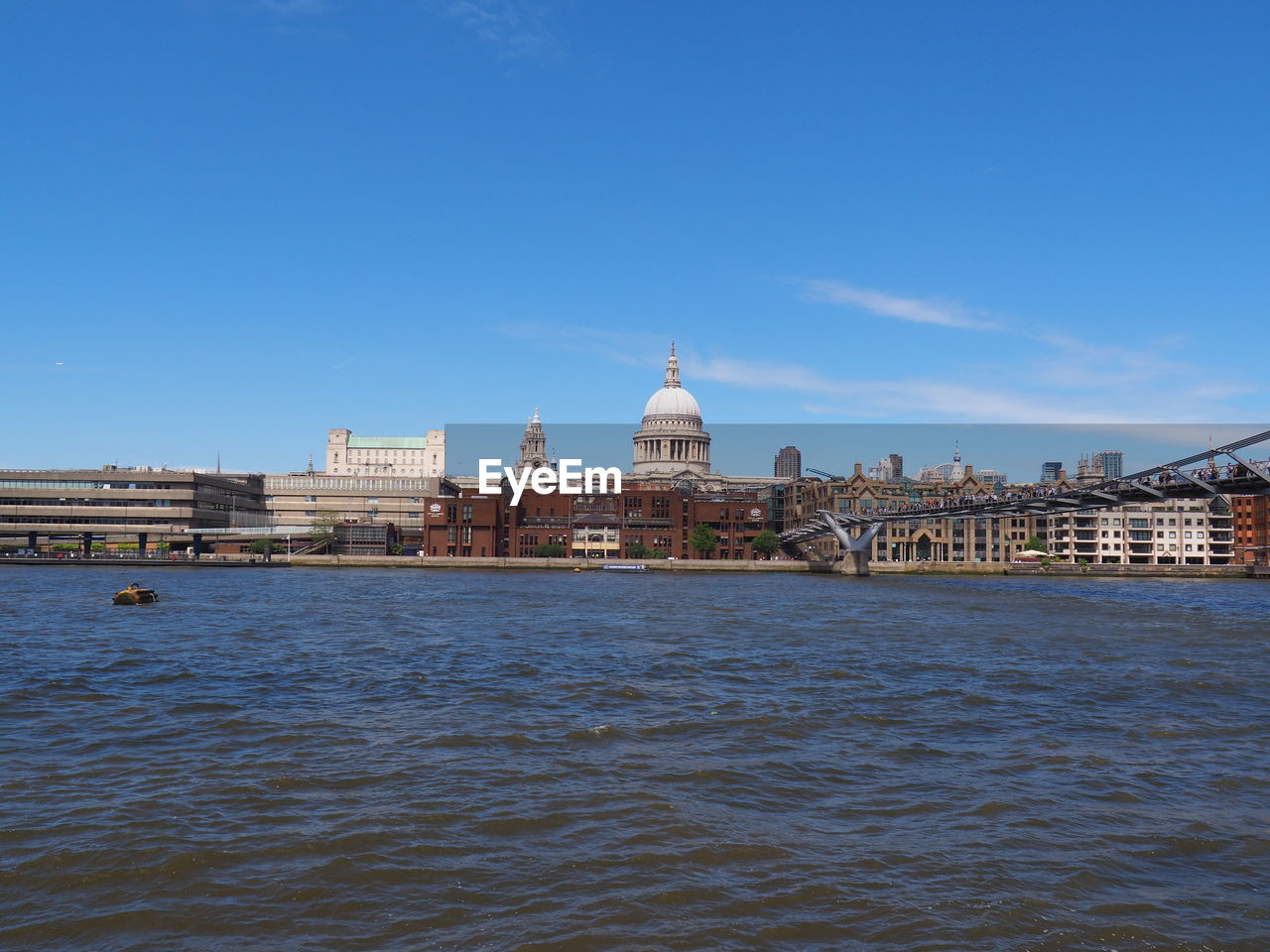 RIVER WITH BUILDINGS IN BACKGROUND