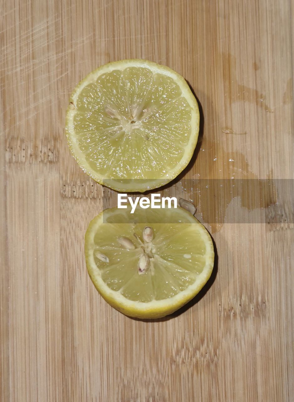 food and drink, fruit, healthy eating, slice, food, citrus fruit, citrus, wellbeing, plant, freshness, lemon, cross section, lime, wood, produce, indoors, no people, table, studio shot, directly above, high angle view, refreshment, halved, still life, drink, close-up