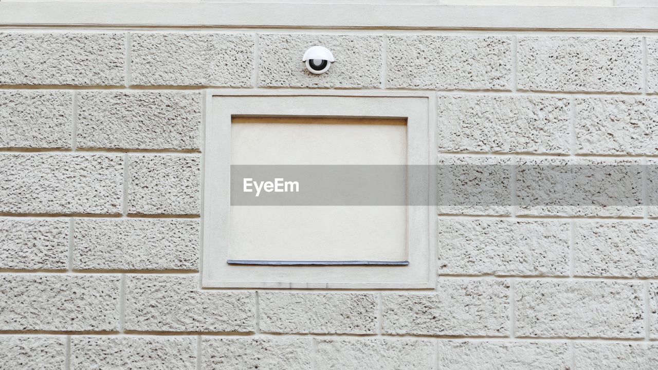 Security camera mounted on wall