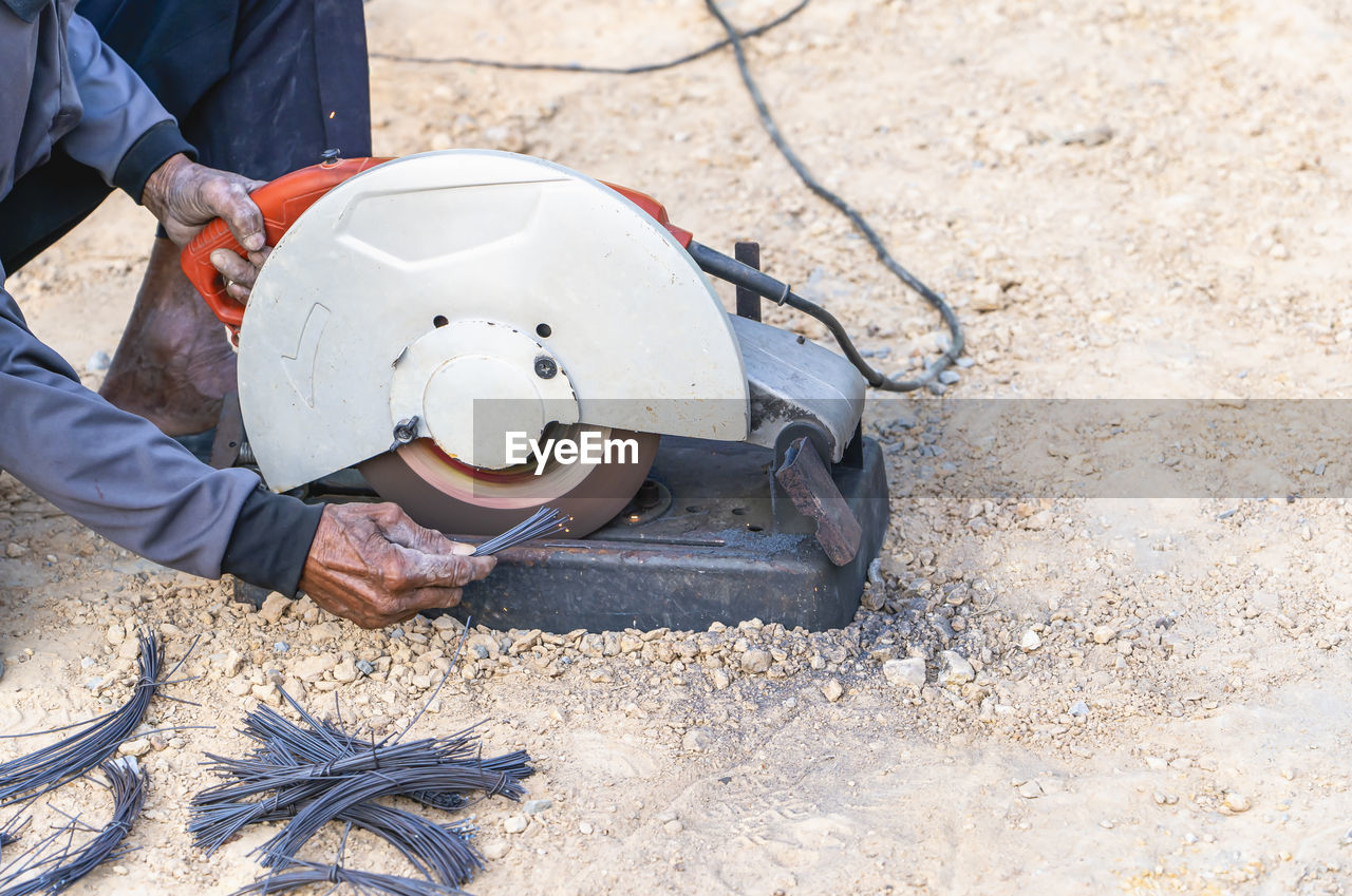 one person, men, occupation, adult, working, clothing, protection, industry, construction industry, manual worker, person, day, nature, headwear, high angle view, helmet, outdoors, land, protective workwear