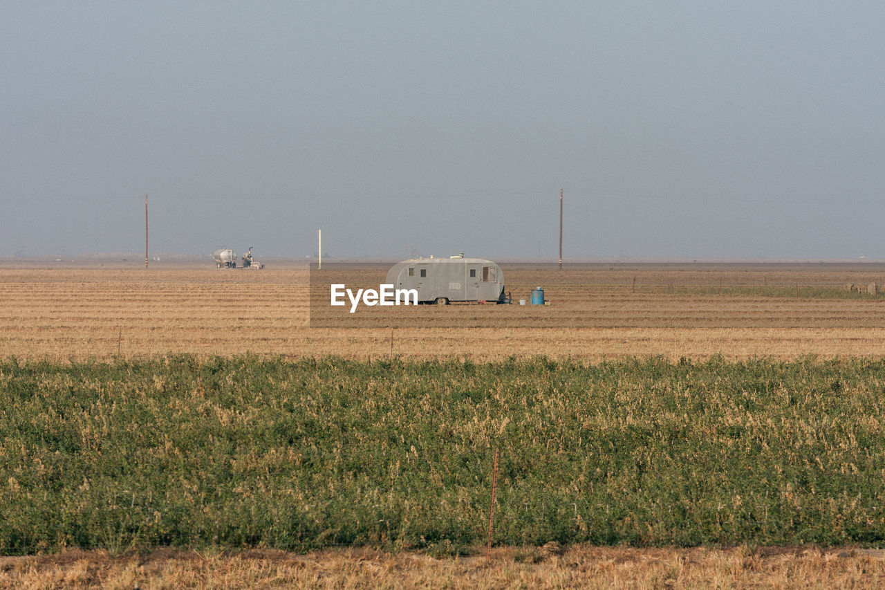 HAY BALES ON FIELD AGAINST SKY