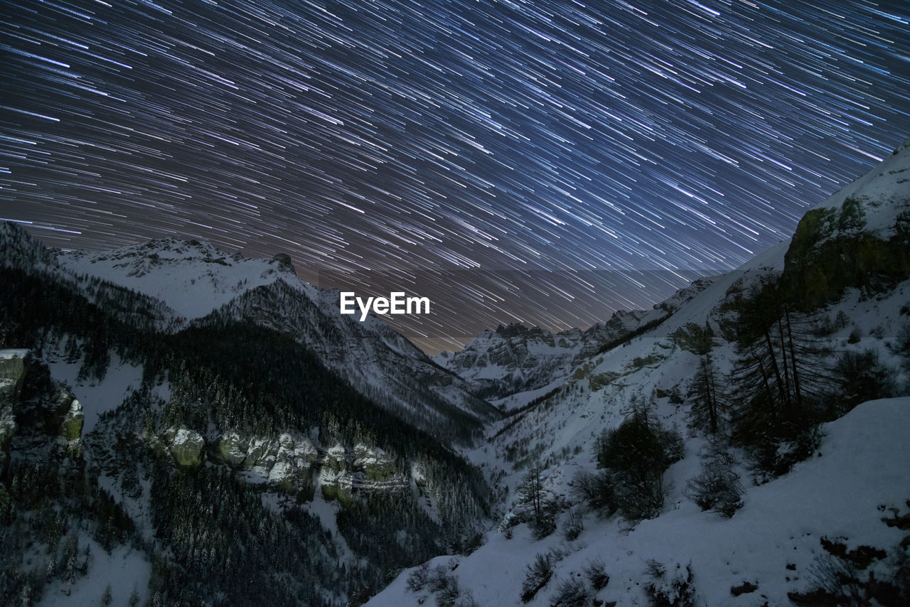 Scenic view of mountains against sky at night