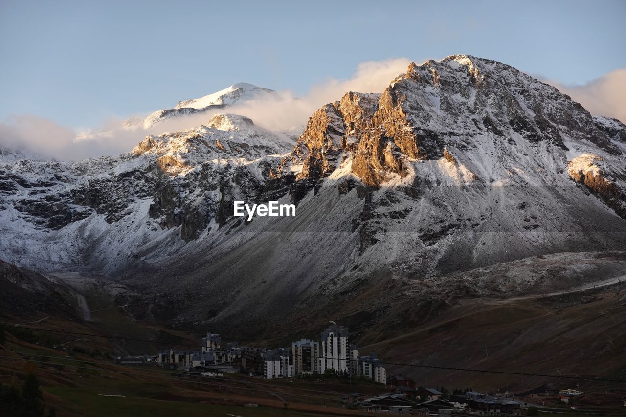 Scenic view of snowcapped mountains against blue sky