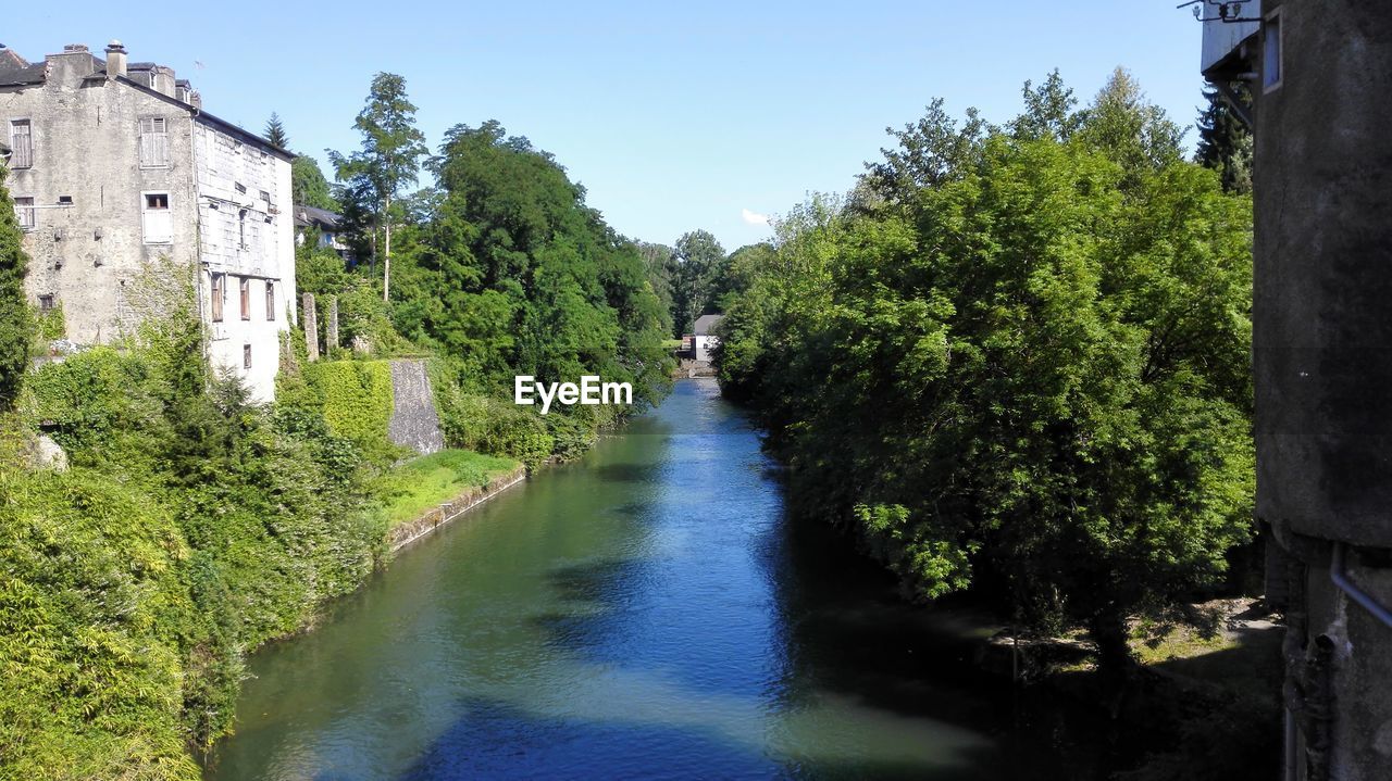 River amidst trees against sky