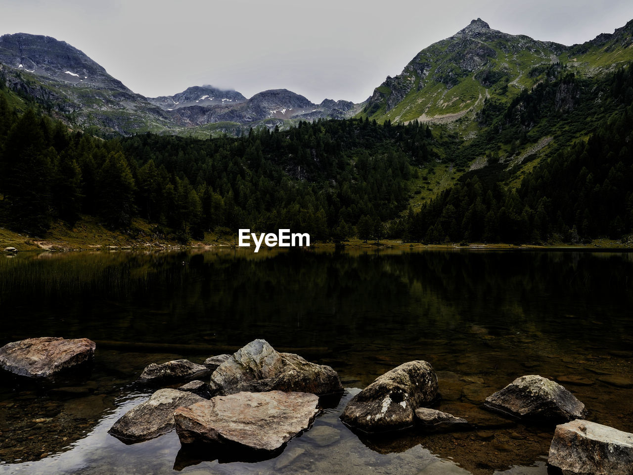 Scenic view of lake and mountains against sky