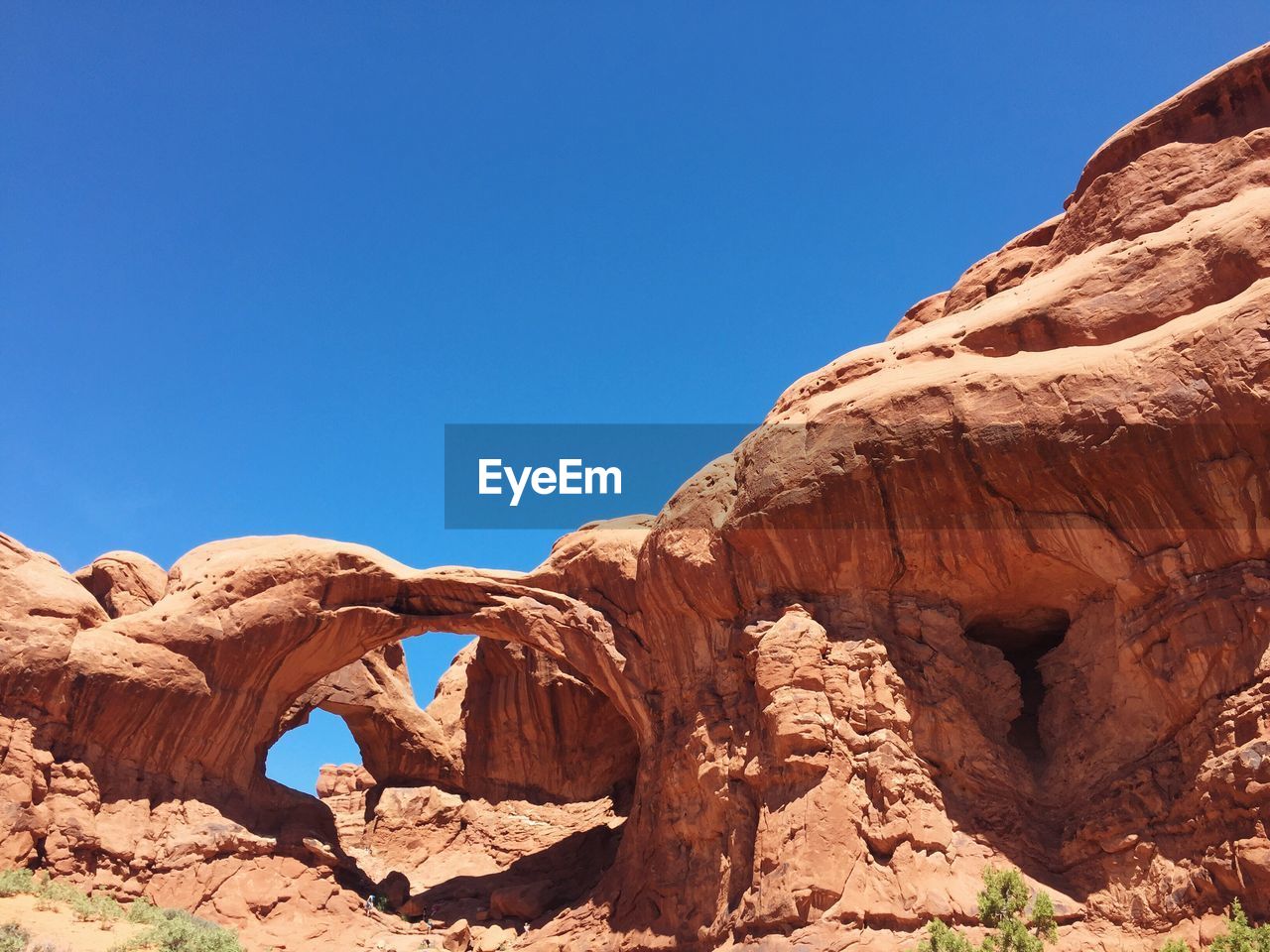 Double arch against clear blue sky at arches national park