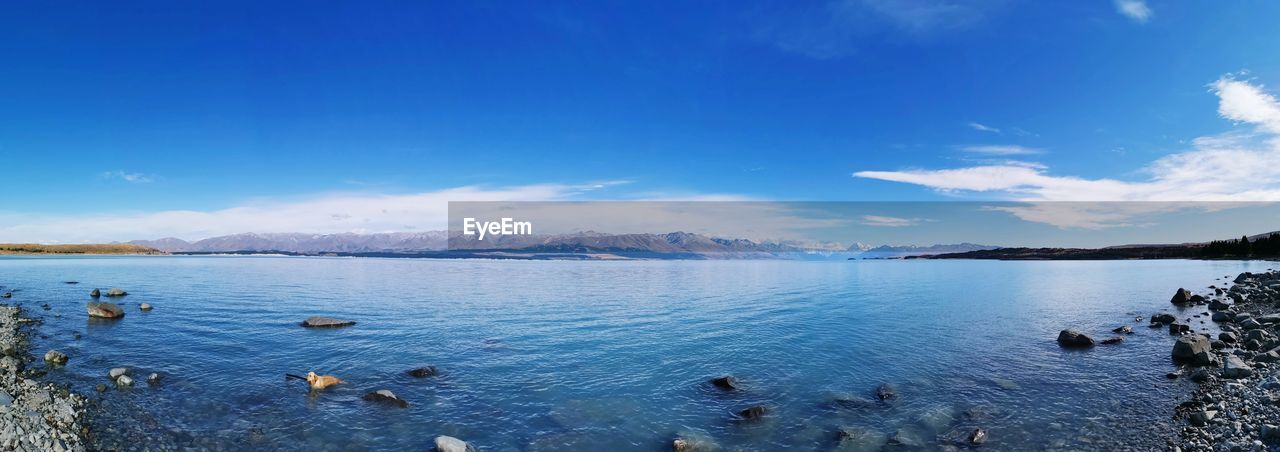 Scenic view of lake against blue sky