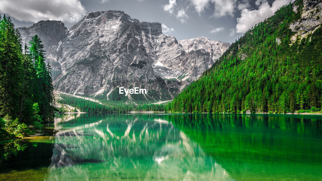 Scenic view of lake pragser wildsee and mountains against sky