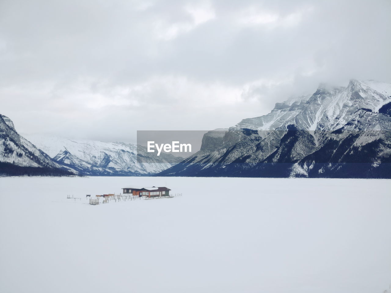 Scenic view of lake by mountains against sky