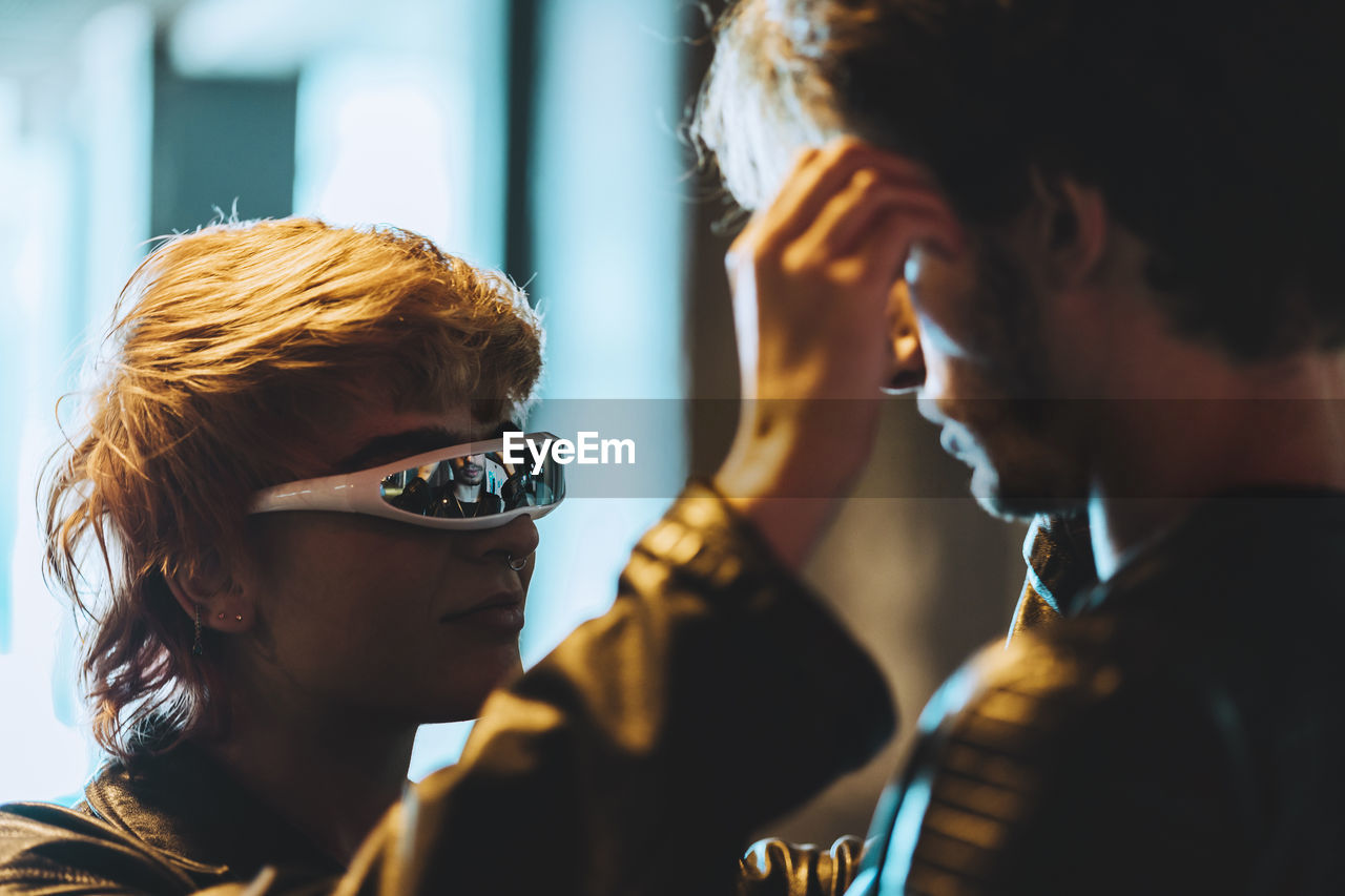 Young woman with smart glasses looking at boyfriend