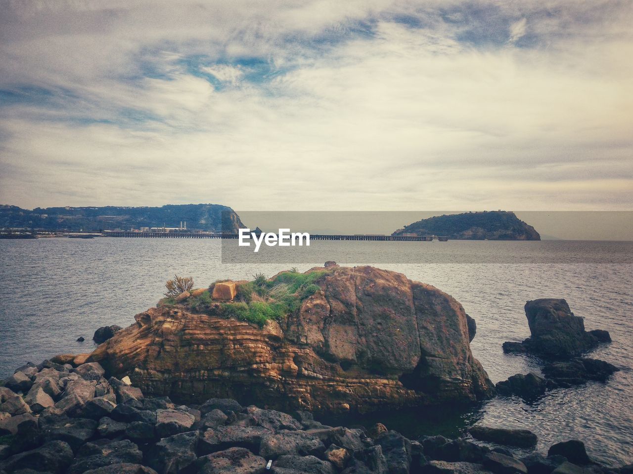 Scenic view of sea and mountains against sky