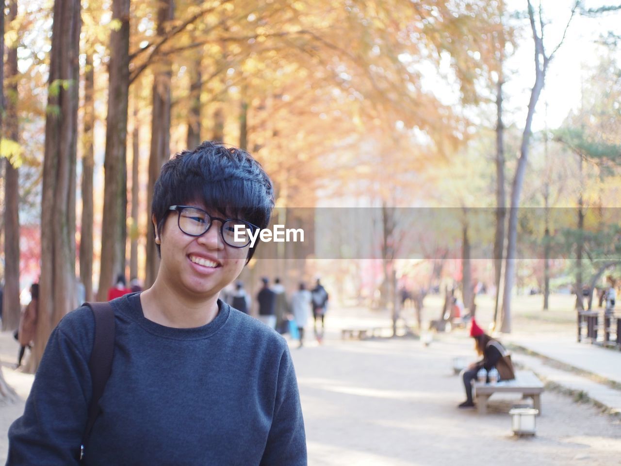 Portrait of smiling man wearing eyeglasses in park