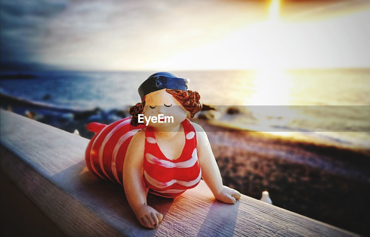 BOY SITTING ON BEACH