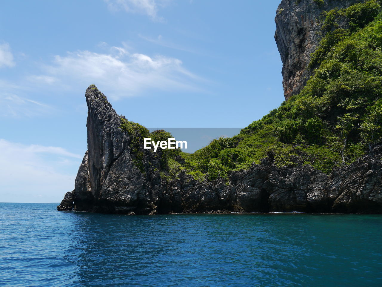 Rock formations in sea against sky